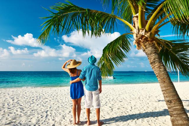 Couple in blue clothes on a beach at Maldives