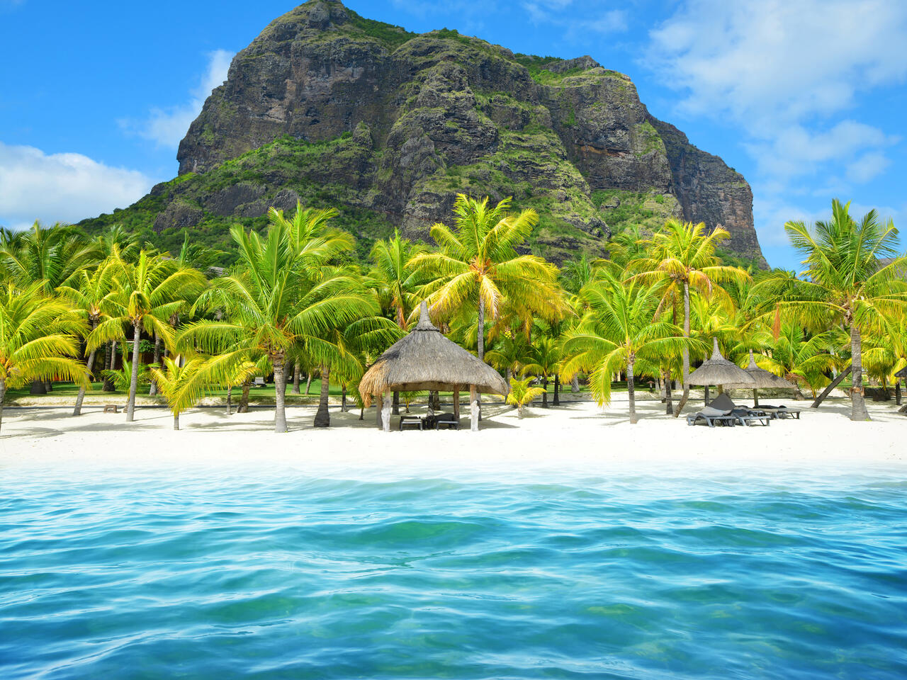 Beautiful sandy beach with Le Morne Brabant mountain on the south of Mauritius island. Tropical landscape.