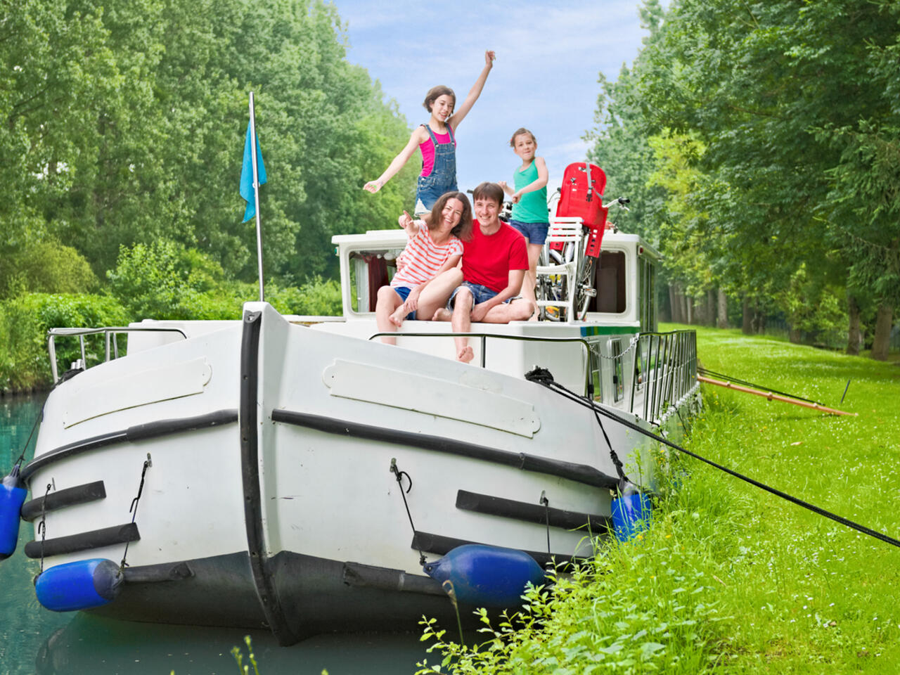 Family vacation, summer holiday travel on barge boat in canal, happy kids and parents having fun on river cruise trip in houseboat in France